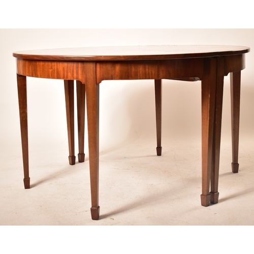 196 - A 19th century George III mahogany extending D-end table with and four chairs. The table having two ... 