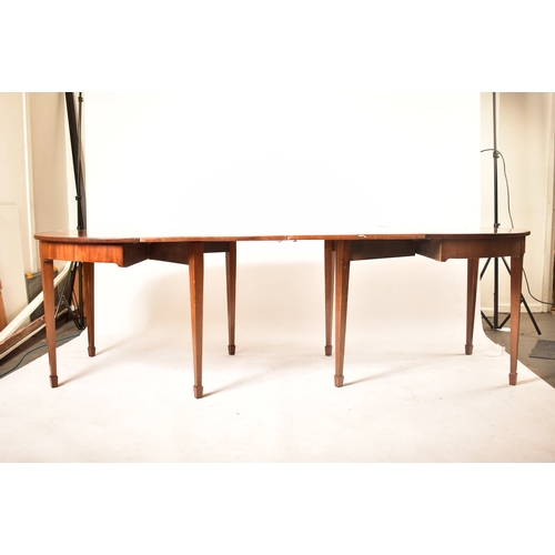 196 - A 19th century George III mahogany extending D-end table with and four chairs. The table having two ... 