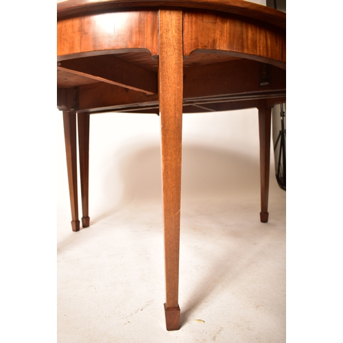 196 - A 19th century George III mahogany extending D-end table with and four chairs. The table having two ... 