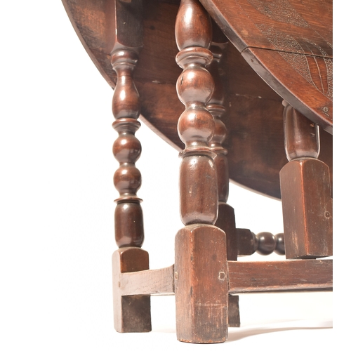 452 - A 19th century carved oak gateleg table. The table having central carved decoration with further det... 