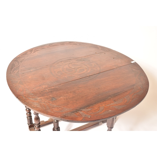 452 - A 19th century carved oak gateleg table. The table having central carved decoration with further det... 