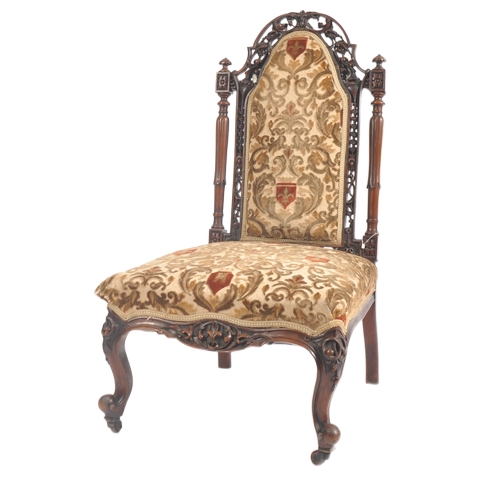 429 - A Victorian 19th century walnut nursing - ladies chair. The chair having a pierced foliate top & bac... 