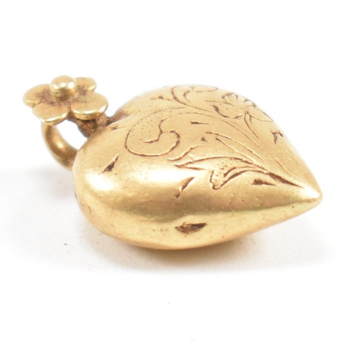 1 - A 19th century gold heart pendant. The pendant having etched foliate decoration with flower set bale... 