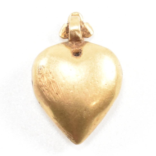 1 - A 19th century gold heart pendant. The pendant having etched foliate decoration with flower set bale... 