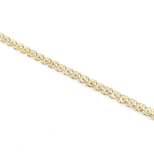 106 - A 9ct gold and diamond line bracelet.  Weight 6.1g / Measures 17.5cm. Marked 10k. All weights, measu... 