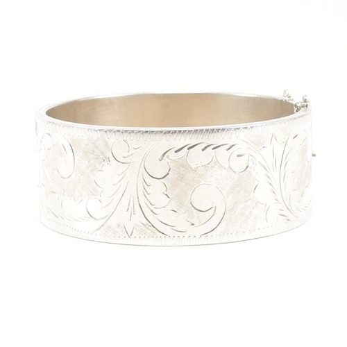 113 - A 925 silver hinged bangle. The bangle having etched foliate decoration to concealed box clasp. Mark... 