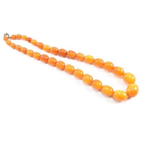 117 - A vintage butterscotch amber bead necklace. The necklace strung with graduating beads from 1.8cm to ... 