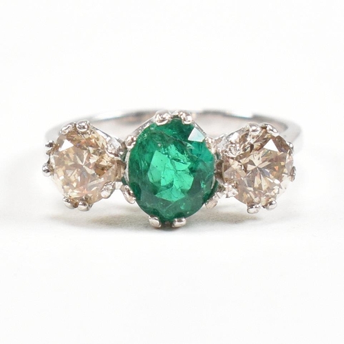 124 - A 18ct white gold emerald and diamond three stone ring. Weight approx 3.6g. Size approx M. Diamonds ... 