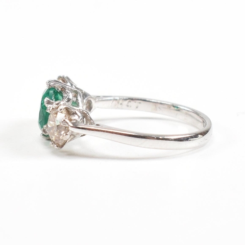 124 - A 18ct white gold emerald and diamond three stone ring. Weight approx 3.6g. Size approx M. Diamonds ... 