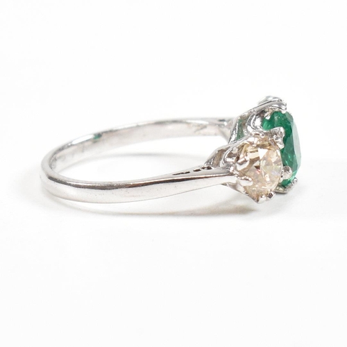 124 - A 18ct white gold emerald and diamond three stone ring. Weight approx 3.6g. Size approx M. Diamonds ... 