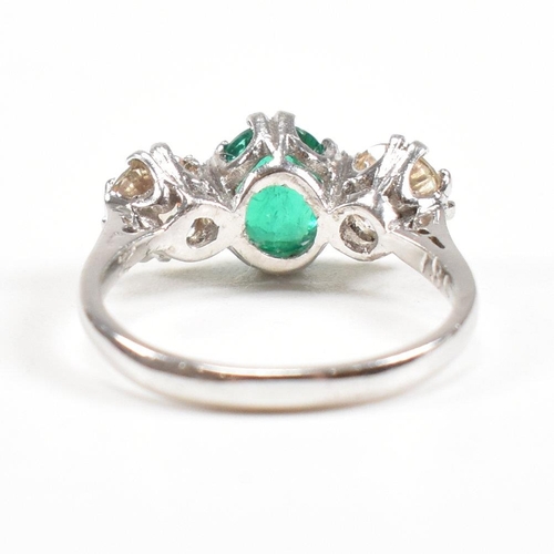 124 - A 18ct white gold emerald and diamond three stone ring. Weight approx 3.6g. Size approx M. Diamonds ... 