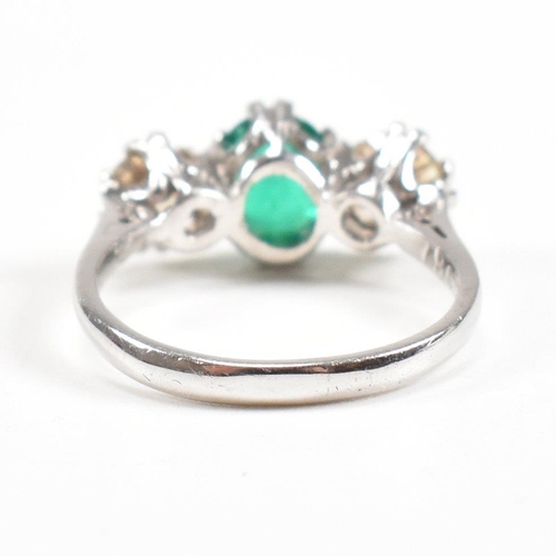 124 - A 18ct white gold emerald and diamond three stone ring. Weight approx 3.6g. Size approx M. Diamonds ... 