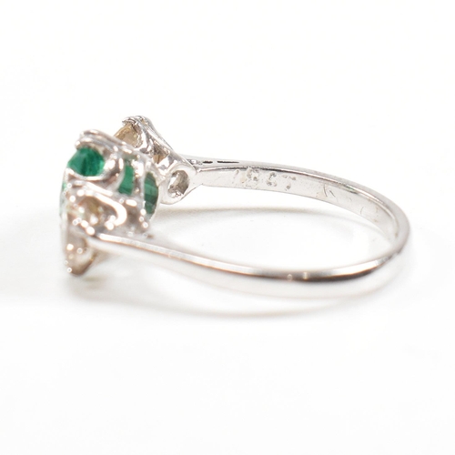 124 - A 18ct white gold emerald and diamond three stone ring. Weight approx 3.6g. Size approx M. Diamonds ... 