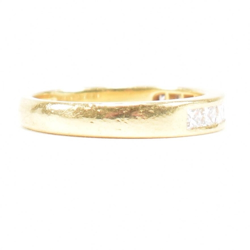 125 - A hallmarked 18ct gold and diamond half eternity ring. The ring set with 9 princess cut diamonds. Es... 