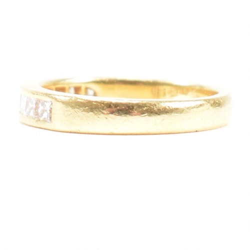 125 - A hallmarked 18ct gold and diamond half eternity ring. The ring set with 9 princess cut diamonds. Es... 