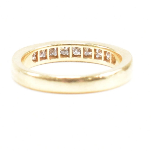 125 - A hallmarked 18ct gold and diamond half eternity ring. The ring set with 9 princess cut diamonds. Es... 