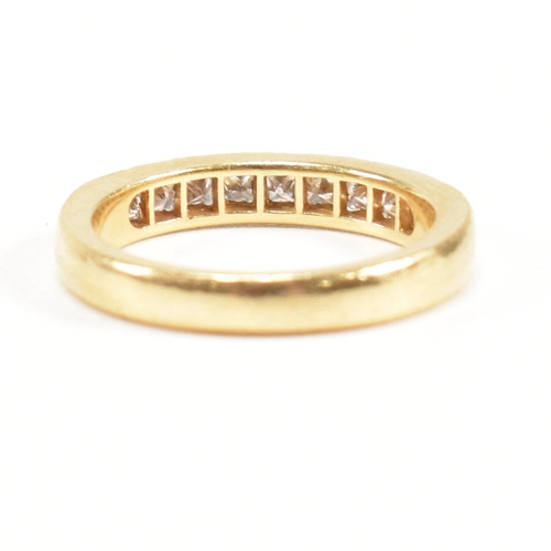 125 - A hallmarked 18ct gold and diamond half eternity ring. The ring set with 9 princess cut diamonds. Es... 