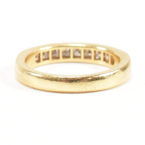 125 - A hallmarked 18ct gold and diamond half eternity ring. The ring set with 9 princess cut diamonds. Es... 