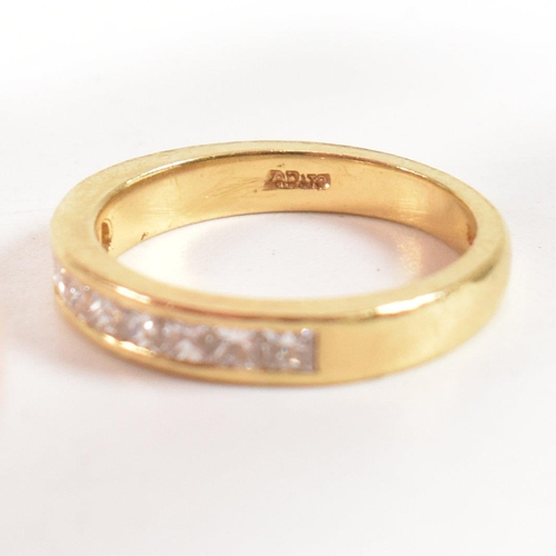 125 - A hallmarked 18ct gold and diamond half eternity ring. The ring set with 9 princess cut diamonds. Es... 