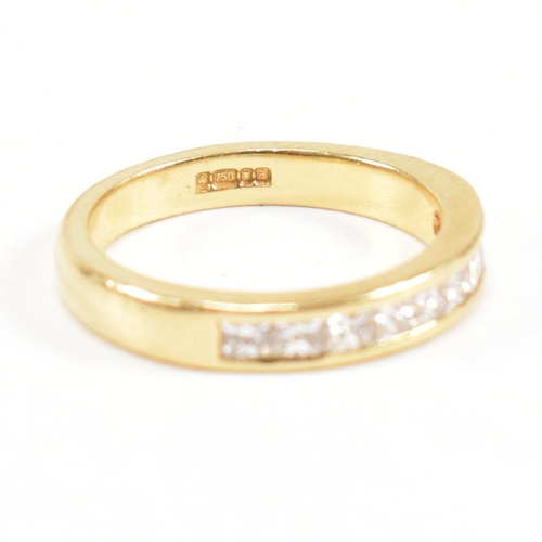 125 - A hallmarked 18ct gold and diamond half eternity ring. The ring set with 9 princess cut diamonds. Es... 