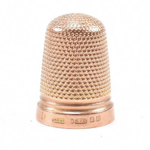 128 - A hallmarked 9ct gold cased thimble. The thimble hallmarked Birmingham 1919, maker HC&S. Weight 4.3g... 