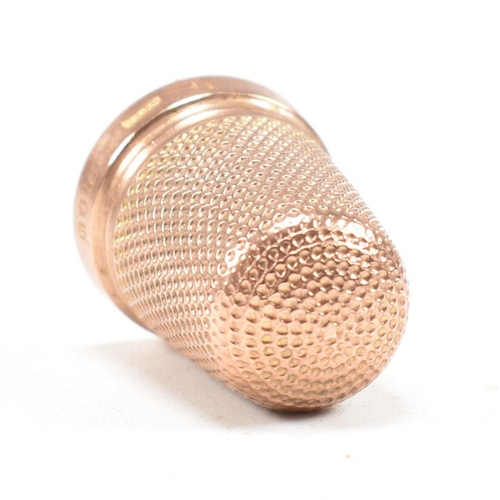 128 - A hallmarked 9ct gold cased thimble. The thimble hallmarked Birmingham 1919, maker HC&S. Weight 4.3g... 