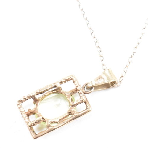 129 - A hallmarked 9ct gold and synthetic spinel pendant necklace. The necklace strung with a brutalist st... 