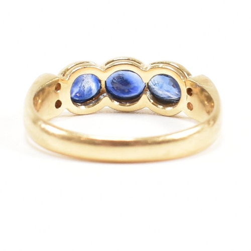 13 - An 18ct gold sapphire and diamond three stone ring. The ring set with three oval cut sapphires havin... 