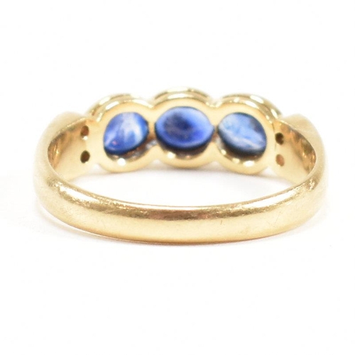 13 - An 18ct gold sapphire and diamond three stone ring. The ring set with three oval cut sapphires havin... 