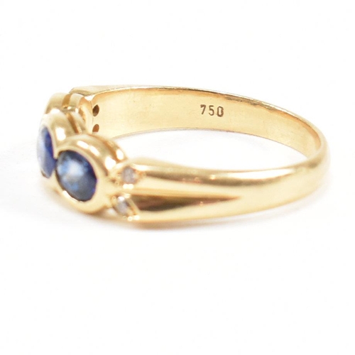 13 - An 18ct gold sapphire and diamond three stone ring. The ring set with three oval cut sapphires havin... 