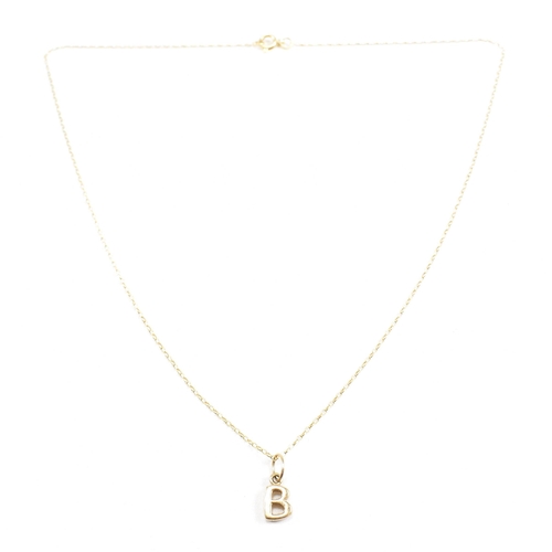 132 - A 9ct gold pendant necklace . The necklace chain strung with a pendant in the form of the letter ini... 