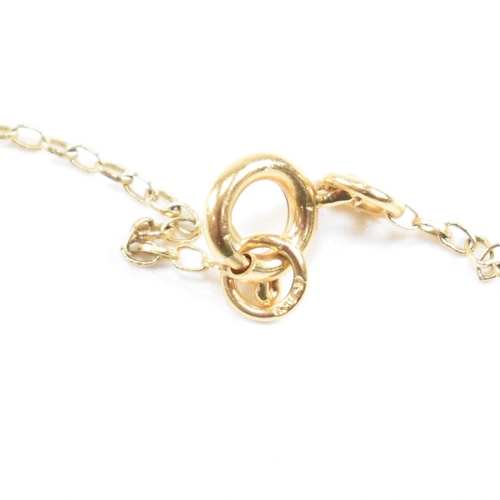 132 - A 9ct gold pendant necklace . The necklace chain strung with a pendant in the form of the letter ini... 