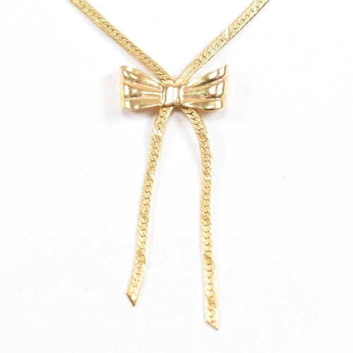 134 - A hallmarked 9ct gold flat link pendant necklace in the form of a ribbon with a bow. Total weight 3.... 