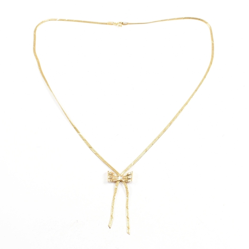 134 - A hallmarked 9ct gold flat link pendant necklace in the form of a ribbon with a bow. Total weight 3.... 