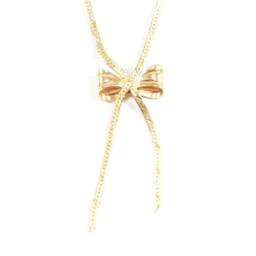 134 - A hallmarked 9ct gold flat link pendant necklace in the form of a ribbon with a bow. Total weight 3.... 