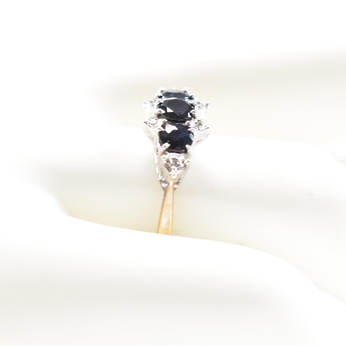 147 - A hallmarked 9ct gold sapphire and diamond cluster ring. Weight 2.4g. Size P. All weights, measureme... 