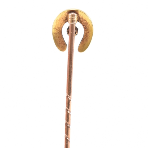 15 - A cased early 20th century gold, pearl and diamond horseshoe stick pin. Case for George Wells Hampst... 