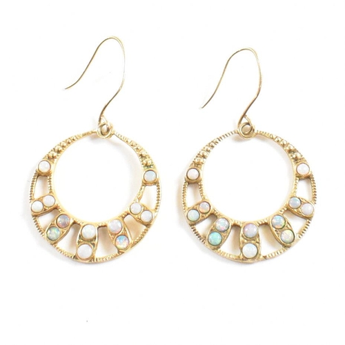 152 - A pair of opal set hoop earrings. The earrings set with opal cabochons to graduating hoops having ho... 