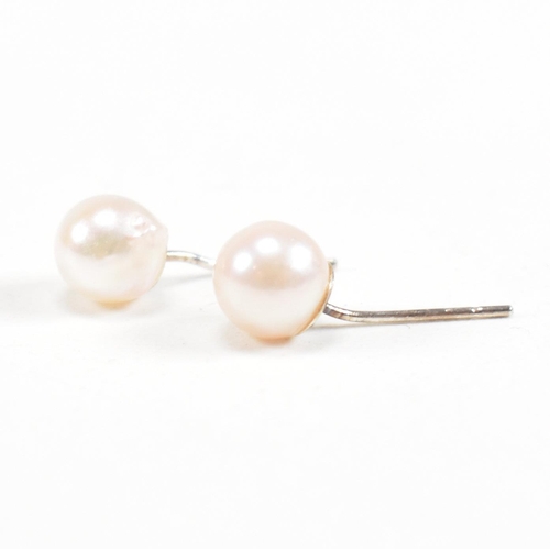 153 - A pair of freshwater pearl and 925 silver earrings. Weight approx 0.7g. Measures approx 0.5cm. All w... 