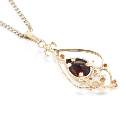 155 - A contemporary hallmarked 9ct gold and garnet Art Nouveau style pendant necklace. Weight 3.6g. Chain... 