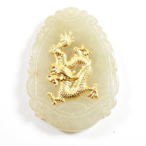 160 - A Chinese jade necklace pendant. The pendant having a gilded Qilin motif to the center of a scrolled... 