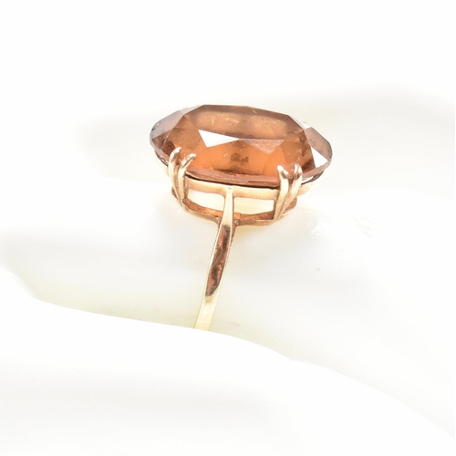 161 - A hallmarked  9ct gold quartz set dress ring. The ring set with a large oval cut quartz to basket mo... 