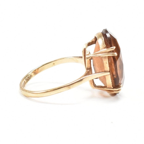 161 - A hallmarked  9ct gold quartz set dress ring. The ring set with a large oval cut quartz to basket mo... 