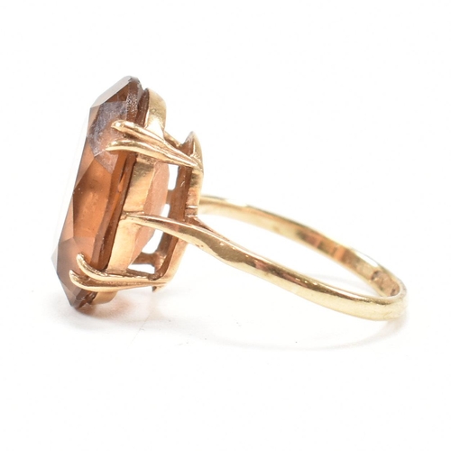 161 - A hallmarked  9ct gold quartz set dress ring. The ring set with a large oval cut quartz to basket mo... 