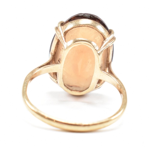 161 - A hallmarked  9ct gold quartz set dress ring. The ring set with a large oval cut quartz to basket mo... 