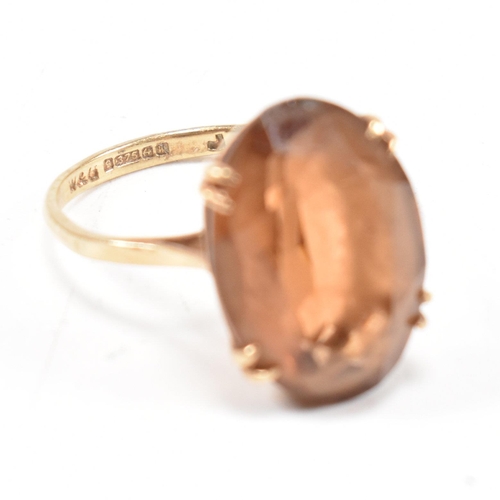 161 - A hallmarked  9ct gold quartz set dress ring. The ring set with a large oval cut quartz to basket mo... 