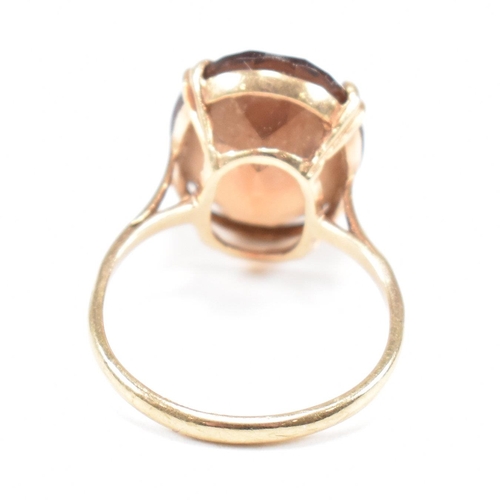 161 - A hallmarked  9ct gold quartz set dress ring. The ring set with a large oval cut quartz to basket mo... 