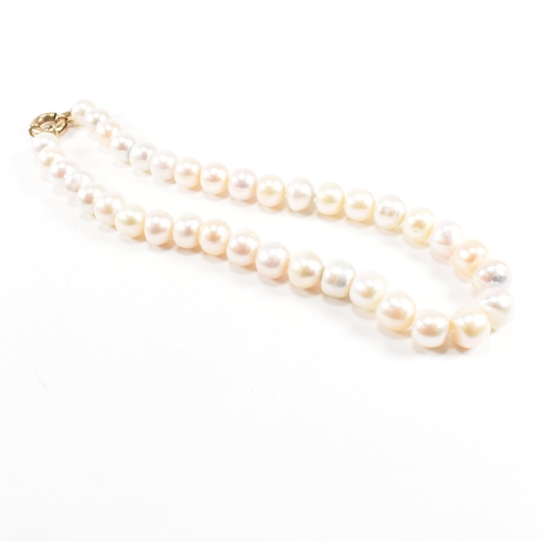 162 - A 9ct old anD cultured pearl bead necklace. The necklace strung with 11mm button pearls to large spr... 