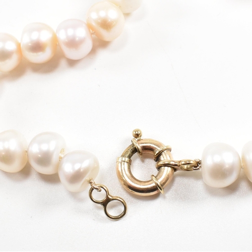 162 - A 9ct old anD cultured pearl bead necklace. The necklace strung with 11mm button pearls to large spr... 