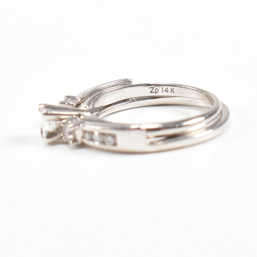 166 - A white gold and diamond stacking ring. Stamped 14k. Weight approx 4g. Size approx L. All weights, m... 